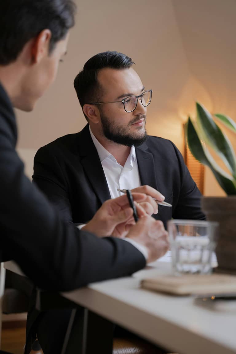 Client discussing tax debt relief options with an IRS Enrolled Agent in professional setting